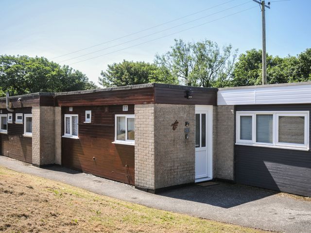 A bungalow exterior with door and windows at 13 Hillside in Bude