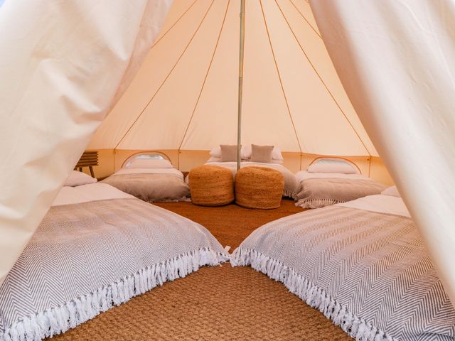 A tent with bedding and pillows at Bell 1 Shades Farm near Malmesbury