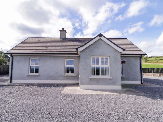 A house with windows and gravel area at Molly's Cottage in Enniskillen