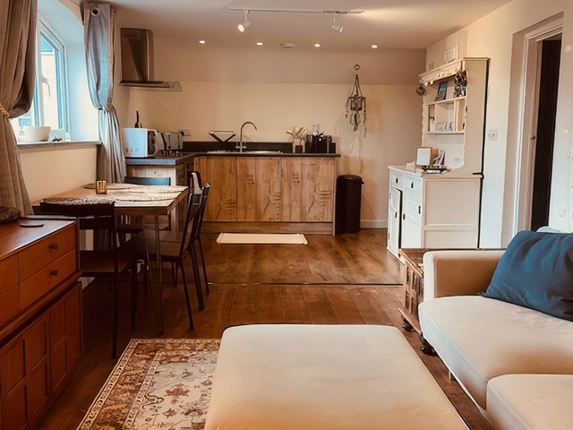 A kitchen with a dining table and chairs at The Hideaway in Tintagel