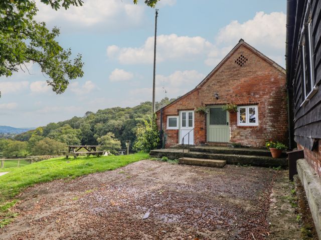 An outdoor view of a brick building with steps and plants at Upper Pandy Farm in Welshpool