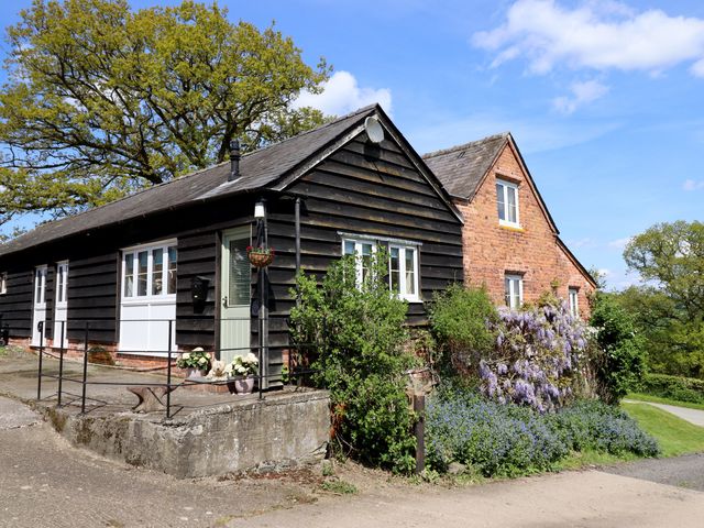A house with a pathway and garden at Upper Pandy Farm Berriew near Welshpool