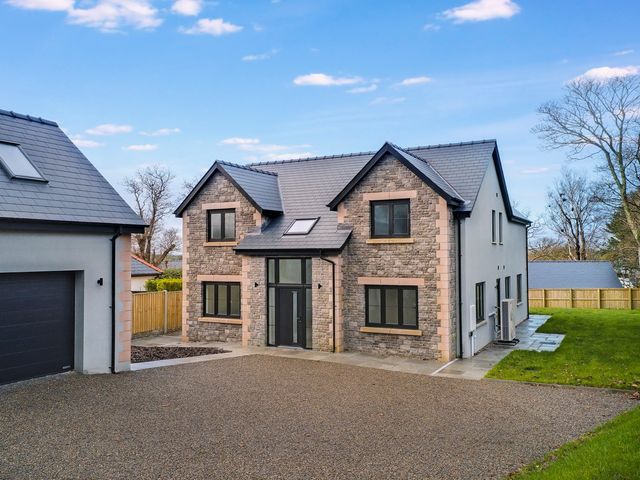 A house with a driveway and garage at Ty Landsker in Milford Haven