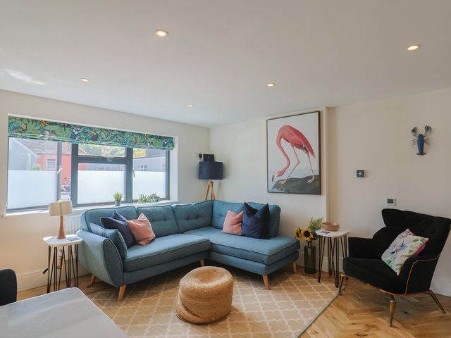 A living room with a sofa and artwork at 1 Mill Green Court Lyme Regis