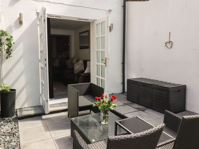 An outdoor patio with seating and a table at Ted's Place in Whitby