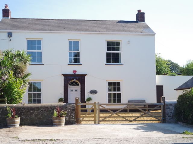 A house with a front door and windows at Littleham Court Manor Littleham near Bideford
