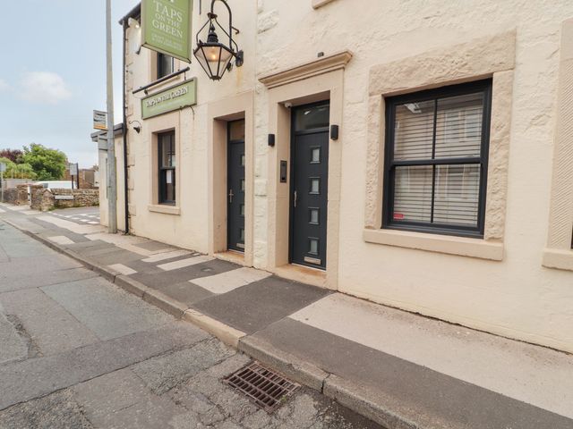 An entrance with doors and windows outside Taps on the Green in Carnforth