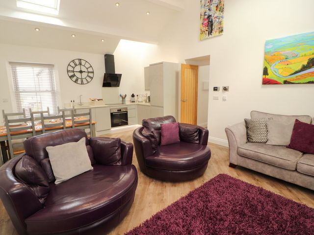 A living room with seating and a dining area at Flat 3 in Carnforth