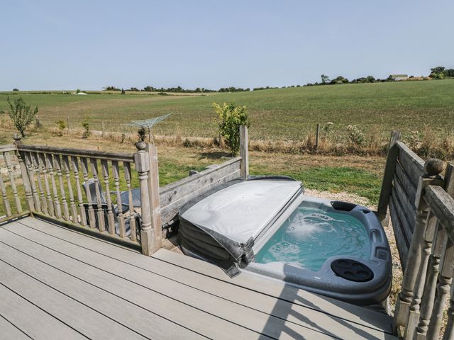 An outdoor area with a hot tub and decking at The Buckland in Pentridge near Sixpenny Handley