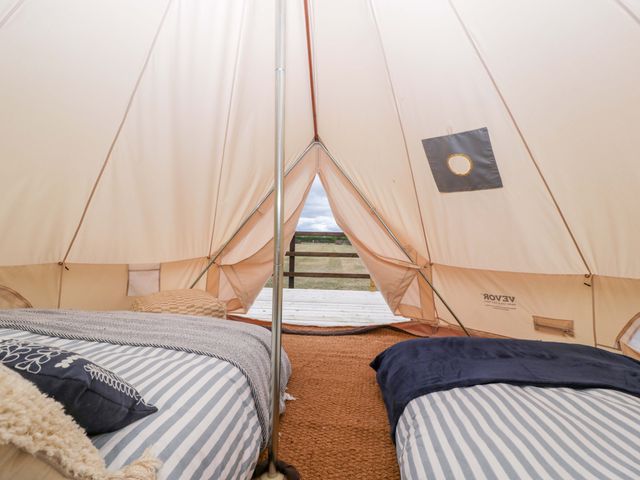 An outdoor tent with beds and pillows at Bell 2 Shades Farm near Malmesbury