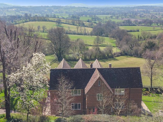 A house surrounded by trees and fields in the countryside at Underhill House