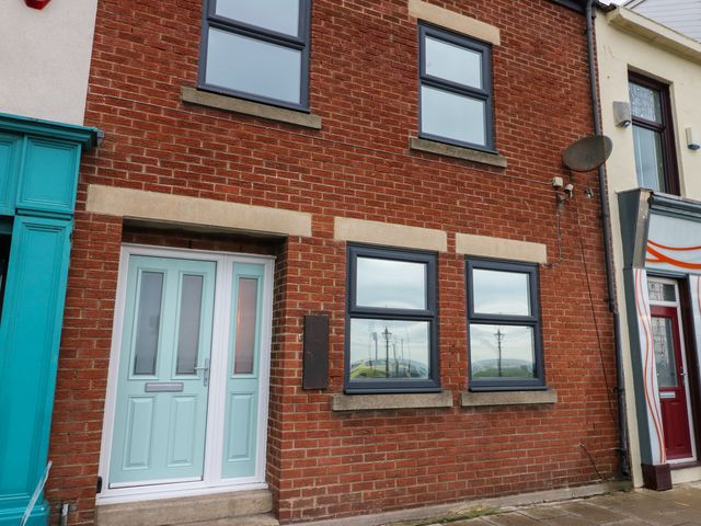 An exterior view of a brick building with windows and a front door at 11 North Terrace Seaham