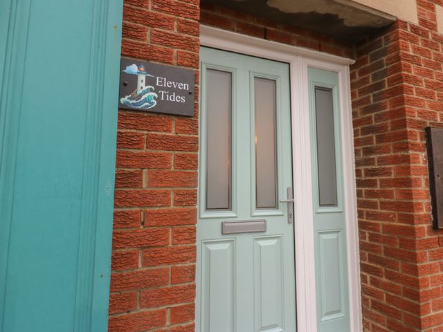 A front entrance door with a nameplate at Eleven Tides in Seaham