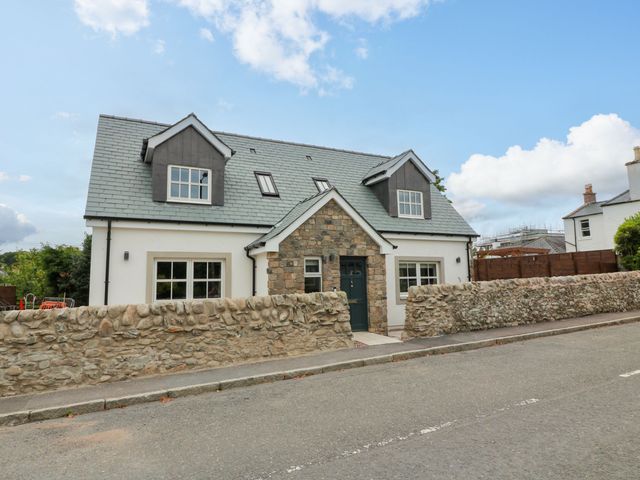 A house with a stone wall and windows at Riverwood House in Gatehouse Of Fleet