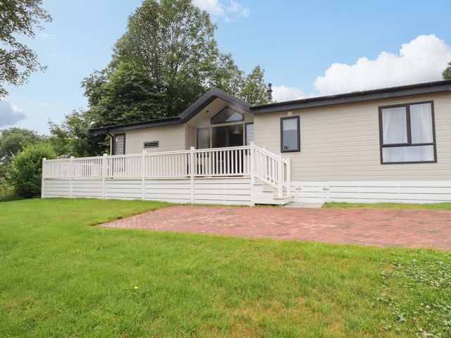 A house with a deck and grass area at The Maples 44 in St. Austell