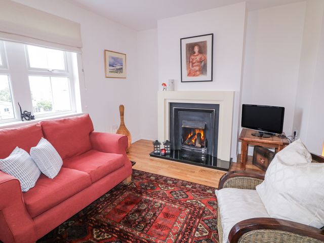 A living room with a sofa and fireplace at Burna in Letterkenny