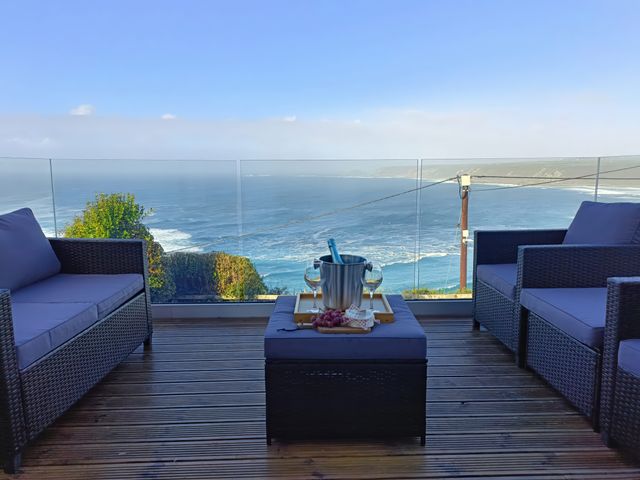 Outdoor seating area with ocean view at Ocean Edge in Sennen Cove