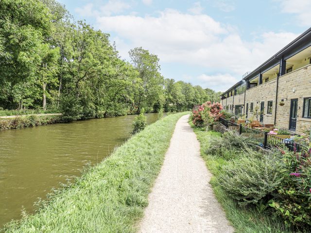 A canal with a path and building alongside at Apartment 5 in Skipton