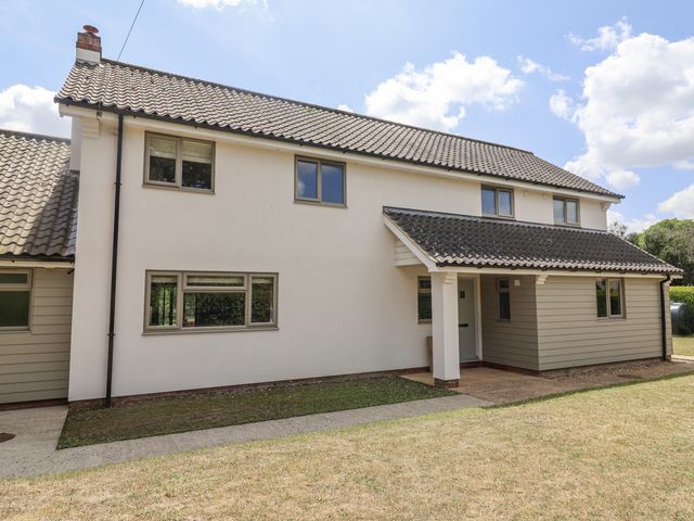 A house with windows and a door at Holly Farm near Brantham