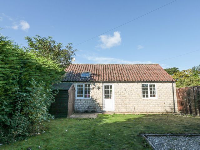 A cottage exterior with a garden at Midsummer Cottage in Malton