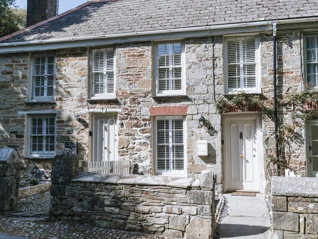 An outdoor view of a stone house with front door and windows at Bluck's cottage in St. Agnes