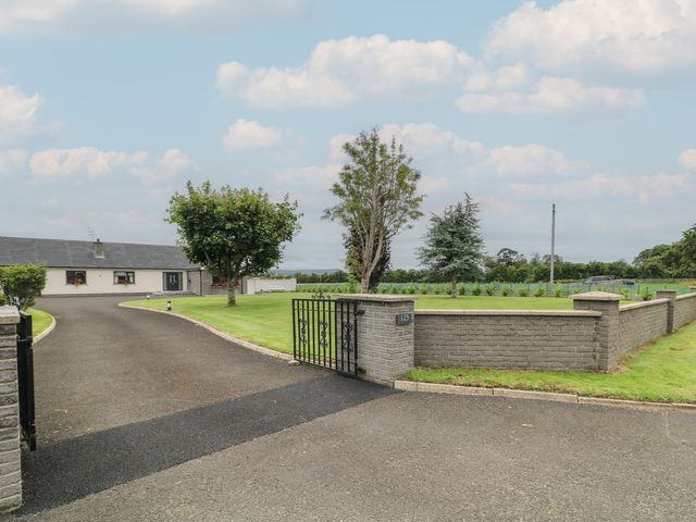 A house with a driveway and trees at Clarmes House in Limavady