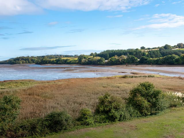 A landscape view of water and grassy areas at Egret in Kingsteignton