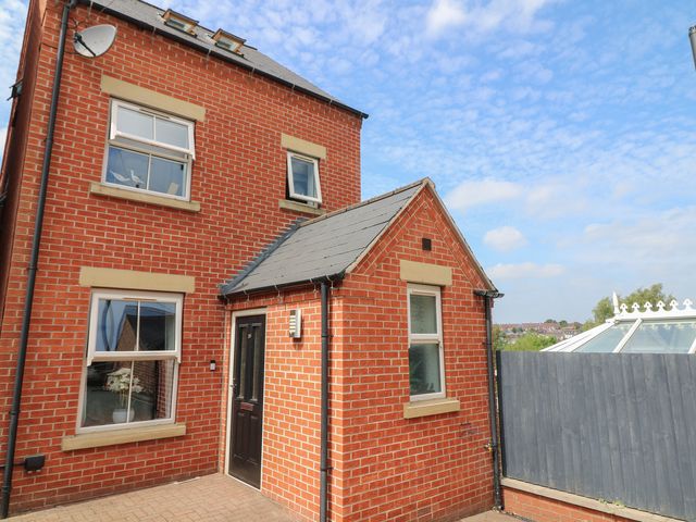 A brick exterior of a house with windows and a door at No 39 Ashbourne