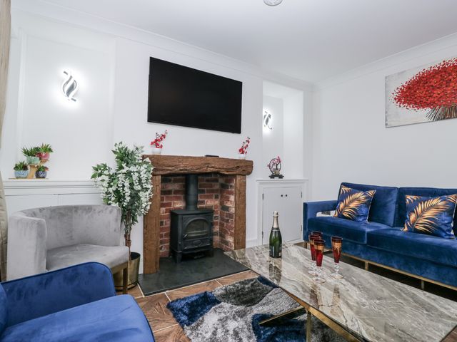 A living room with a fireplace and sofa at Aspen Boutique