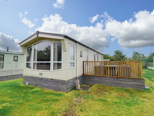 A static caravan with a decking area at Beach Retreat E19 Dyffryn Seaside Estate Dyffryn Ardudwy