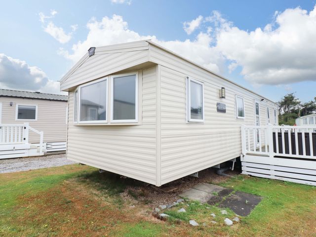 A mobile home with steps on a patio at Beachcombers Barmouth Bay Holiday Park Talybont