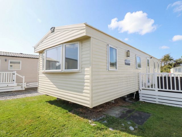 A caravan with windows and steps at Beachcombers Barmouth Bay Holiday Park Talybont near Dyffryn Ardudwy
