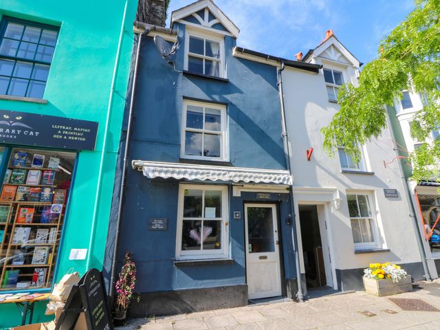A storefront with a blue building and shop sign at The Little Laura Ashley House Machynlleth