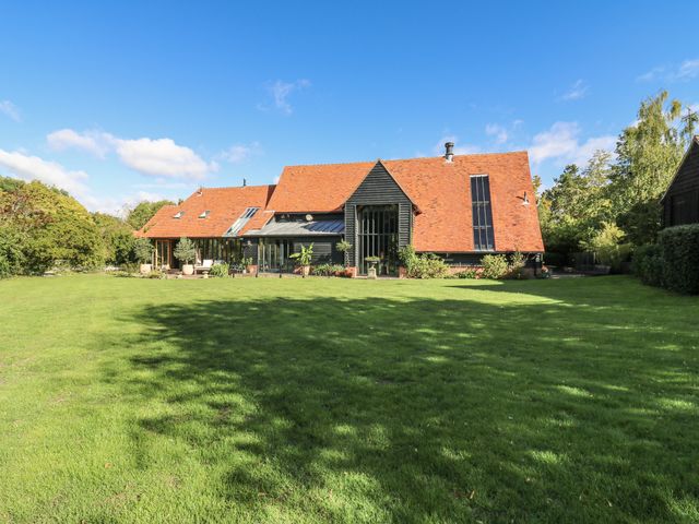 A house with a large garden and trees at Headland Barn in Maldon