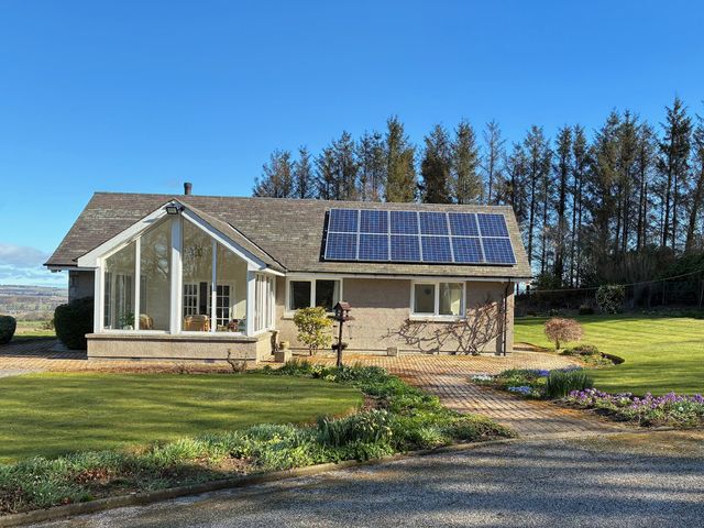 A house with solar panels and garden at Carnmhor Blackburn, Aberdeenshire