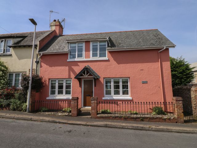 A house with a pink exterior and windows at 13 School Road Newton Abbot