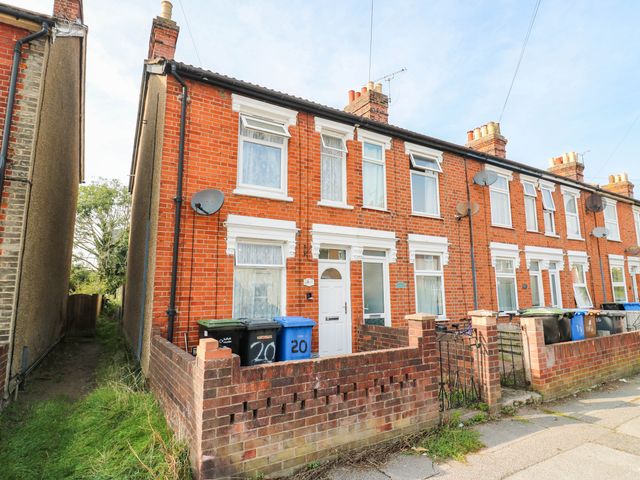 A red brick house with windows and a front garden at Dover Retreat