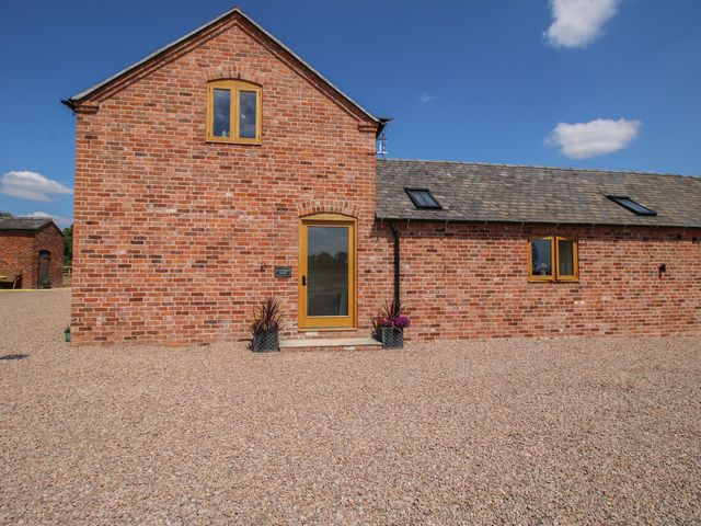A house exterior with brick walls and a front door at Chestnut Barn, Shrewsbury