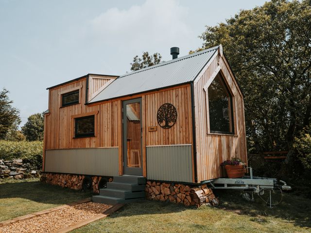 A wooden house with a door and windows at Driftwood in Carreglefn near Llanfechell