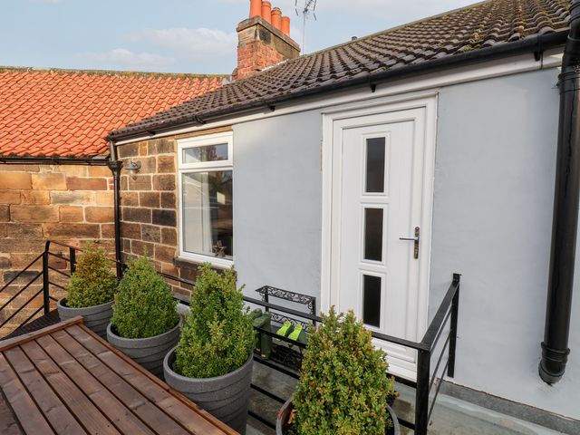 An outdoor area with a door and planters at Postman’s Lodge in Great Ayton