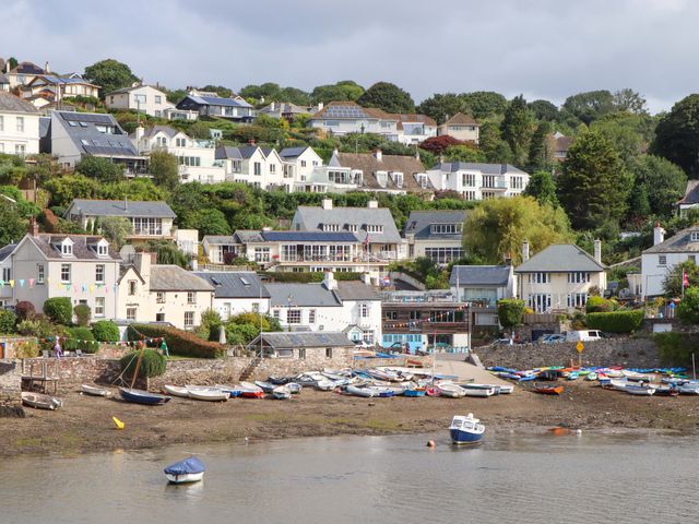 A coastal scene with houses and boats at The Porthole in Newton Ferrers