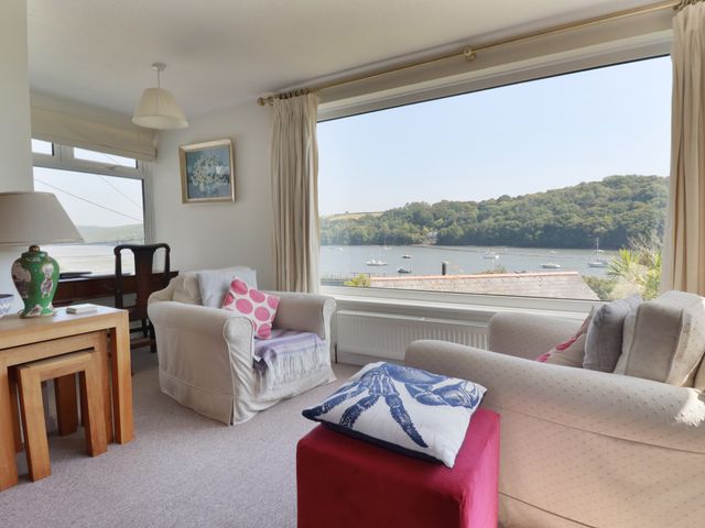 A living room with a view of the water at Kiln Cottage in Golant near Tywardreath