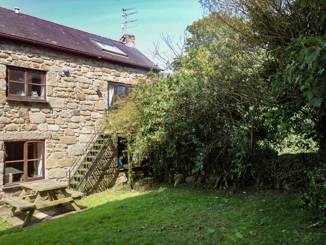 A house exterior with windows, stairs, and a picnic table at Mill House Barn in Gulval near Penzance