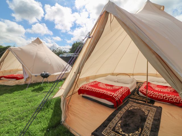 A tent with beds and blankets at Bell Tent Two