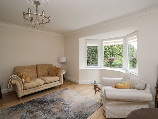 A living room with a sofa and armchair at 7 Belfort Court 