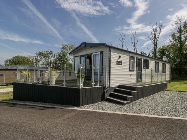 A caravan with steps and glass railing at Grasmoor View Lodge