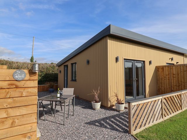 An outdoor area with a table and chairs at The Roost in Whitford Nr. Colyton