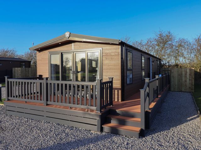 A cabin with decking and windows at Meadows Park 2 Great Hatfield near Hornsea