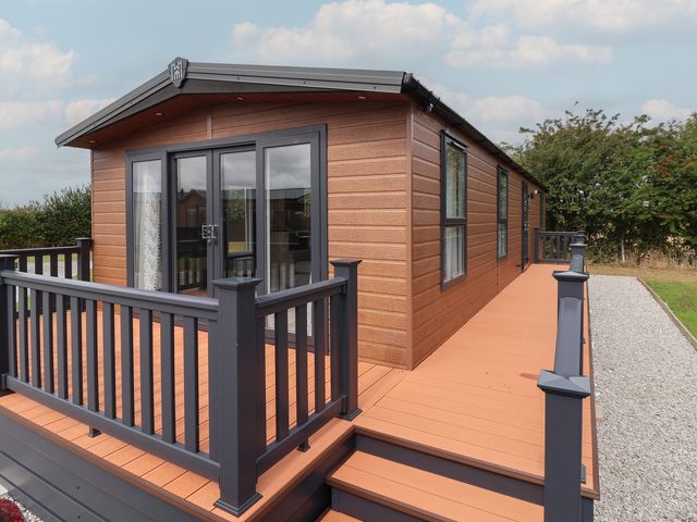 A lodge exterior with a deck and steps at Meadows Park 3 Great Hatfield near Hornsea