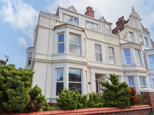 A residential building with windows and bushes at Mariners Lee